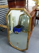 AN ANTIQUE OCTAGONAL GILT WALL MIRROR WITH REEDED FRAME AND BEVEL PLATE. 103 x 57cms.