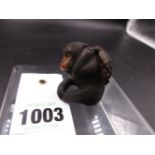 A JAPANESE CARVED WOOD FIGURE OF A SEATED MONKEY HOLDING A BUNCH OF GRAPES, SIGNED. H.4cms.