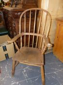 A 19th.C.COUNTRY WINDSOR ARMCHAIR RETAINING TRACES OF PERIOD PAINT DECORATION.