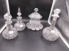 THREE VARIOUS GLOBE AND SHAFT CUT GLASS DECANTERS WITH STOPPERS AND A HEAVY CUT GLASS SWEETMEAT JAR,