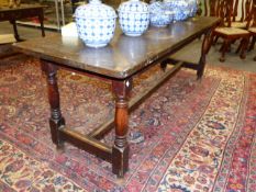 A 19th.C.OAK LONG REFECTORY DINING TABLE ON TURNED LEGS UNITED BY H-STRETCHER. 213 x 68 x H.77cms.