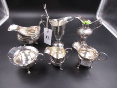 A GROUP OF GEORGIAN AND LATER HALLMARKED SILVER CREAMERS TOGETHER WITH AN EMBOSSED SMALL EWER.