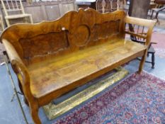 A 19th.C.CONTINENTAL PAINTED PINE SETTLE WITH SHAPED PANEL BACK AND SPINDLE ARMS. W.182cms.