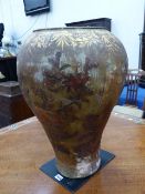 A LARGE ANTIQUE POTTERY VASE OF BULBOUS FORM WITH DECOUPAGE AND GILT FERN DECORATION. H.56cms.