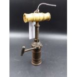 A VICTORIAN BONE HANDLED BRASS TAP ACTION CORKSCREW.