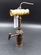 A VICTORIAN BONE HANDLED BRASS TAP ACTION CORKSCREW.