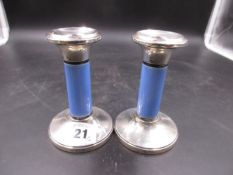 A PAIR OF SILVER CANDLESTICKS WITH BLUE ENAMEL COLUMNS. B'HAM 1923, HENRY CLIFFORD DAVIS.