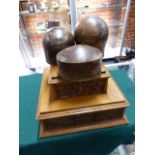THREE ANTIQUE WOODEN TREEN HAT BLOCKS.AND A VICTORIAN CARVED OAK DISPLAY PLINTH. (4)
