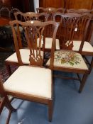 A SET OF SIX CARVED WALNUT COUNTRY GEORGIAN DINING CHAIRS WITH GOTHIC REVIVAL BACK SPLATS. (ONE