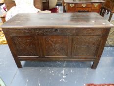 AN 18th.C.OAK COFFER WITH TWO PLANK TOP OVER CARVED PANEL FRONT ON STILE SUPPORTS. W.124 x H.66 x