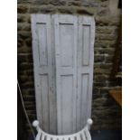 A PAIR OF ANTIQUE PINE PANEL FOLDING WINDOW SHUTTERS. OVERALL W.100 x H.178cms.