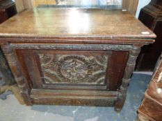 AN ANTIQUE AND LATER CARVED OAK BOX WITH CENTRAL BIRD PANEL. 65 x 41 x H.54cms.