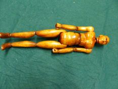 AN ARTIST'S ARTICULATED WOODEN LAY FIGURE MANNEQUIN. H.35cms.