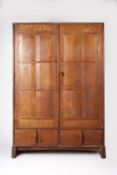 SIDNEY BARNSLEY (1865-1926) OR PETER WAALS (1870-1937 AN ARTS AND CRAFTS HAND MADE OAK CUPBOARD/ W