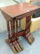 A NEST OF TABLES IN THE ORIENTAL STYLE WITH RED LACQUER DECORATION AND DRAGON CARVED FEET. (4)