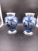 TWO SIMILAR DELFT BLUE AND WHITE COMPRESSED BALUSTER VASES EACH PAINTED WITH A RESERVE OF A MAN