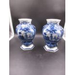 TWO SIMILAR DELFT BLUE AND WHITE COMPRESSED BALUSTER VASES EACH PAINTED WITH A RESERVE OF A MAN