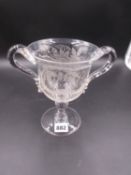 AN EARLY 19th.C. GLASS TWO HANDLED LOVING CUP, THE BELL SHAPED BOWL ENGRAVED ON ONE SIDE WITH