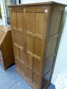 ALAN GRAINGER. ACORNMAN. AN OAK HALL CABINET WITH HAND ADZE FINISH TO THE PAIR OF EIGHT PANEL