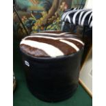 A VINTAGE LEATHER AND ZEBRA HIDE POUFFE STOOL. Dia.40cms