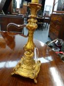 A GILT METAL TABLE LAMP BASE WITH WINGED GRIFFIN DECORATION ON PAW FEET. OVERALL H.41cms.