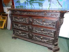 AN ITALIAN CARVED WALNUT EARLY FOUR DRAWER BAROQUE STYLE CHEST WITH ARMORIAL PANELLED ENDS, EACH