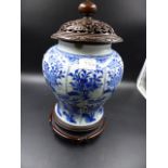 A CHINESE BLUE AND WHITE BALUSTER VASE WITH CARVED HARDWOOD STAND AND COVER. OVERALL H. 33cms.