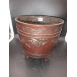 A JAPANESE BRONZE TRIPOD PLANTER, THE EXTERIOR CAST IN RELIEF WITH LONG TAILED BIRDS FLYING ABOUT