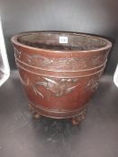 A JAPANESE BRONZE TRIPOD PLANTER, THE EXTERIOR CAST IN RELIEF WITH LONG TAILED BIRDS FLYING ABOUT