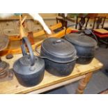 A GROUP OF ANTIQUE IRON COOKING PANS, A RANGE KETTLE AND A SET OF SCALES AND WEIGHTS.