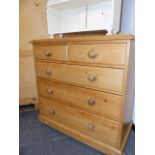 A VICTORIAN PINE CHEST OF TWO SHORT AND THREE LONG GRADUATED DRAWERS ON BUN FEET. 106 x 54 x H.