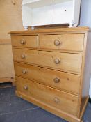 A VICTORIAN PINE CHEST OF TWO SHORT AND THREE LONG GRADUATED DRAWERS ON BUN FEET. 106 x 54 x H.