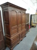 AN 18th.C.LARGE COUNTRY OAK LIVERY CUPBOARD WITH TWO DOOR AND PANELLED UPPER SECTION OVER