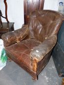 A VICTORIAN TUB ARMCHAIR WITH LEATHER UPHOLSTERY.