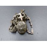 AN ANTIQUE VULCANITE MOURNING LOCKET AND CHAIN CONTAINING A PORTRAIT OF A LADY IN 19th C. DRESS.