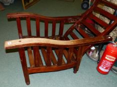 A PAIR OF ANTIQUE TEAK RECLINING ARMCHAIRS IN THE ARTS AND CRAFTS MANNER. (2)