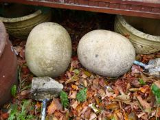 A PAIR OF EGG FORM STONE GATEPOST FINIALS.