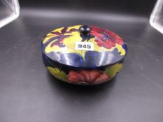 A MOORCROFT HIBISCUS PATTERN ROYAL BLUE GROUND COVERED BOWL.