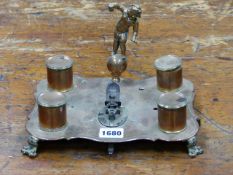 AN UNUSUAL ANTIQUE BELL METAL AND BRASS STANDISH WITH FOUR HOLDERS AND FIGURAL FINIAL, CENTRAL