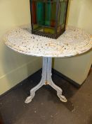 AN ANTIQUE CAST IRON PATIO GARDEN TABLE ON TRI-FROM SUPPORT. Dia.68 x H.76cms.