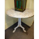 AN ANTIQUE CAST IRON PATIO GARDEN TABLE ON TRI-FROM SUPPORT. Dia.68 x H.76cms.