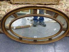 A 19th.C.OVAL WALL MIRROR WITH MARGINAL SECTION FRAME. 78 x 52cms.