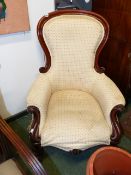 A VICTORIAN MAHOGANY SHOW FRAME ARMCHAIR ON SCROLL SUPPORTS.