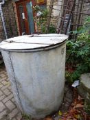 A LARGE GALVANIZED CYLINDRICAL GRAIN BIN.