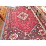 AN AFGHAN SMALL CARPET.