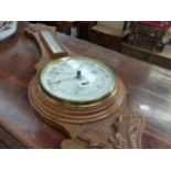 A VICTORIAN CARVED OAK BAROMETER.