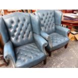 A PAIR OF BUTTON LEATHER WING BACK ARMCHAIRS.