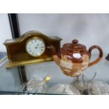 A BRASS CASED CLOCK AND A DOULTON TEAPOT.