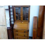 A SMALL OAK BUREAU BOOKCASE.