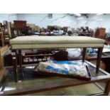 A LARGE FOOTSTOOL AND AN EASTERN BRASS INLAID TABLE.